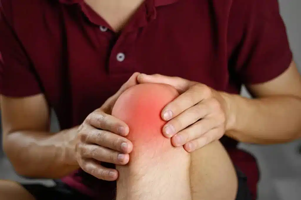 the-guy-clings-to-his-knee-experiencing-ligament-injury-care-wellington-florida 1